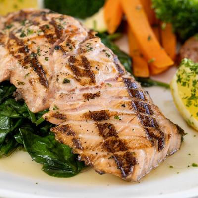 Grilled Atlantic Salmon Served over sauteed spinach and vegetables.
