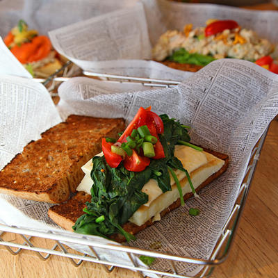 Sandwich with cheese and salad, slice of bread on the side