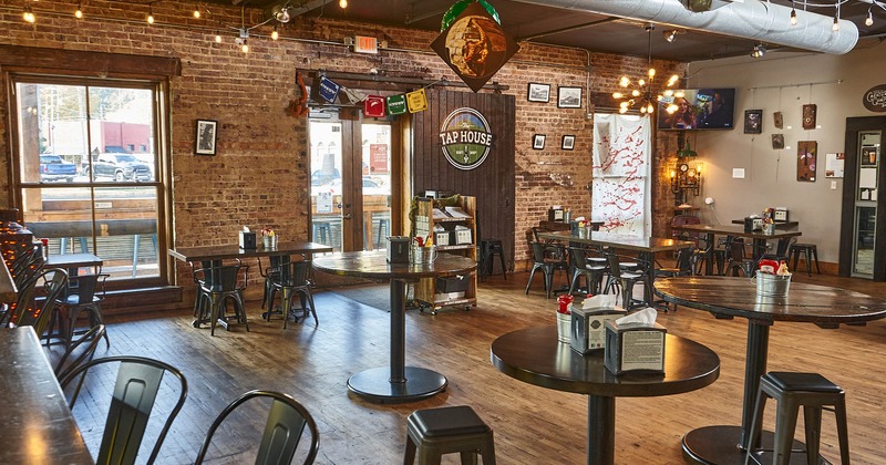 Interior, large windows, entrance, lighting, wall decorations, tables, chairs