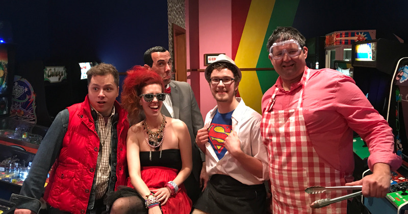 A group of people in costumes at an arcade