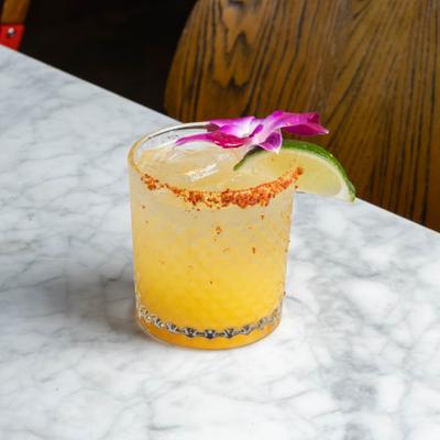 Yellow drink with tejin rim, orchid and lime.