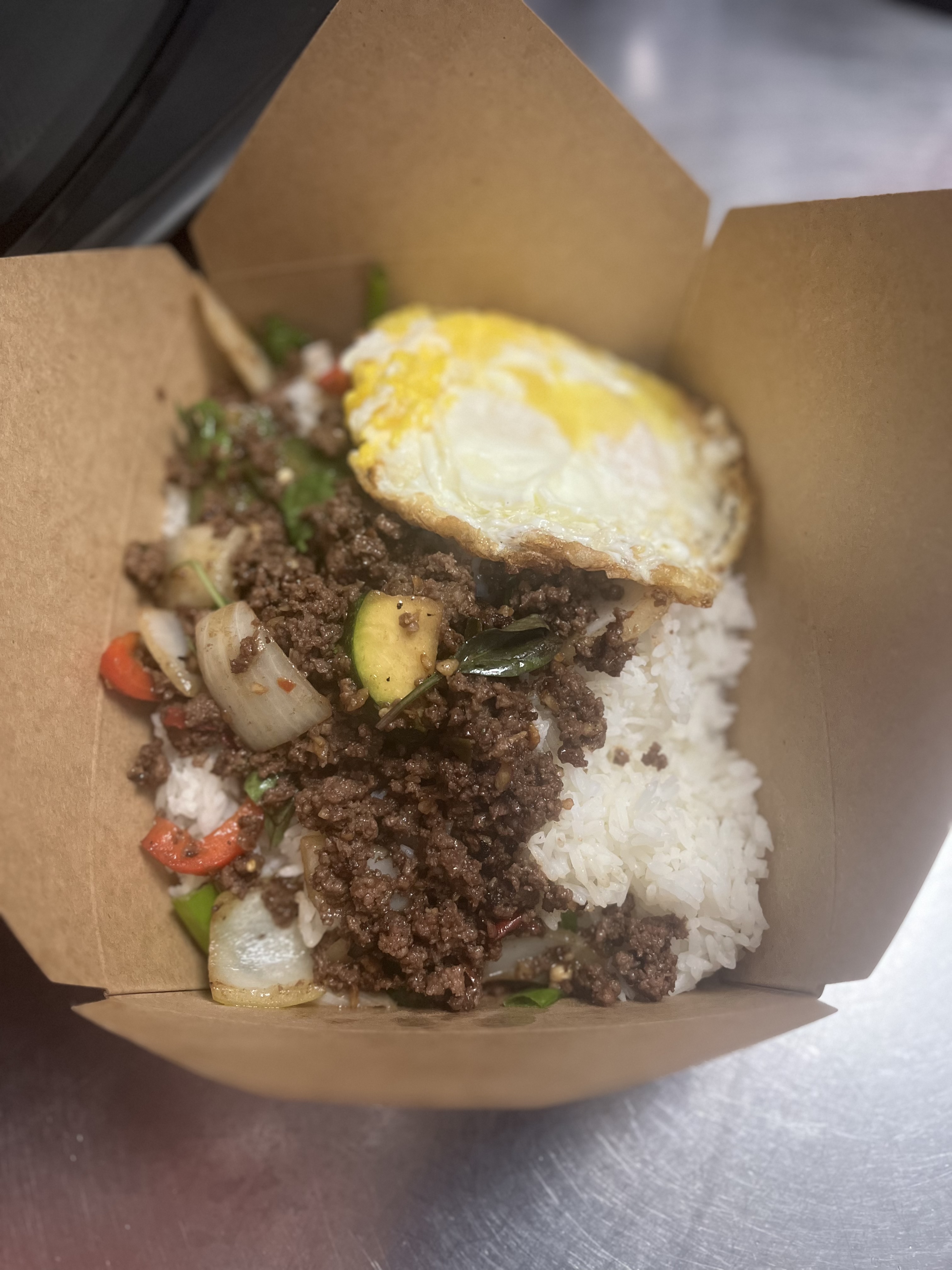 Spicy ground beef over rice with fried eggs.