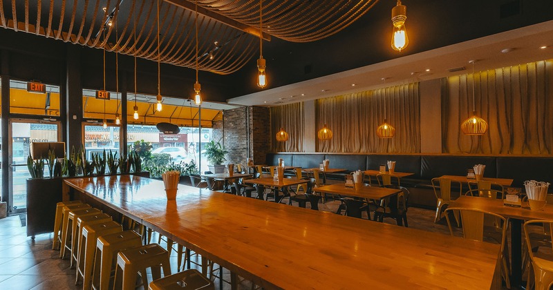 Restaurant interior, seating area with a large table in the center