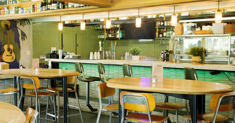 Interior, tables and seats near a bar