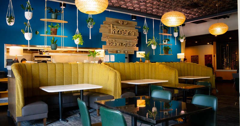 Interior, dining area, ''U'' shaped seating booths with tables, hanging plant pots decoration