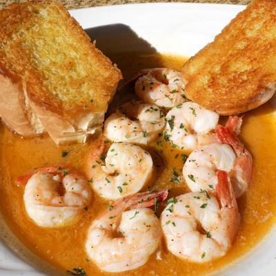 Shrimp sauteed in white wine butter sauce, served with bread.