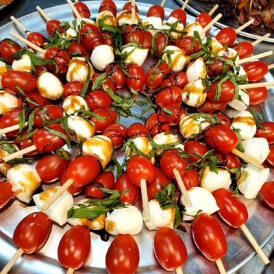 Caprese skewers made with cherry tomatoes, mini mozzarella balls, and fresh basil leave.