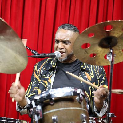 A drummer playing live.