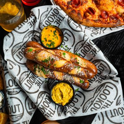 Pretzel sticks served with beer cheese and mustard.