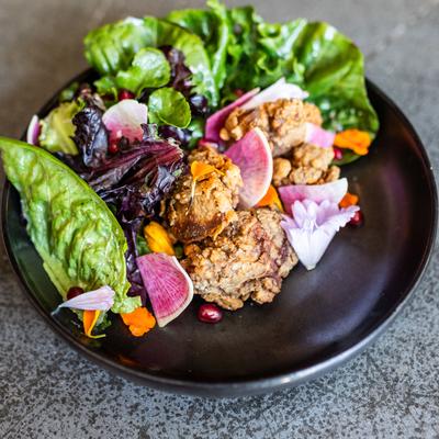colorful salad greens and radishes with fried chicken livers