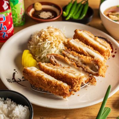 Cheese Tonkatsu, served with cabbage and white rice.