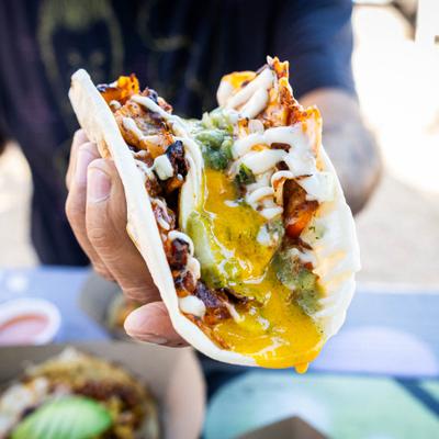 Hand holding a ChilaquilesTaco.