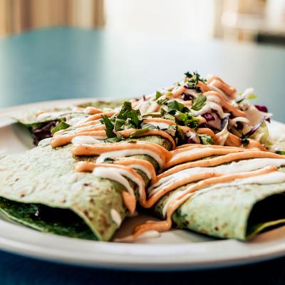 Green pastry with dip on top