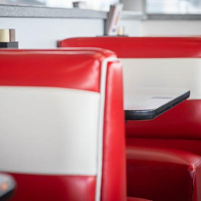 A close-up of red-and-white leather booths.