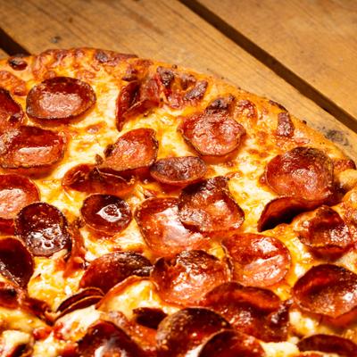 Double pepperoni pizza, closeup, top view.