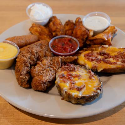 Sampler Platter, with buffalo wings, mozzarella sticks, chicken fingers, potato skins, and dip.
