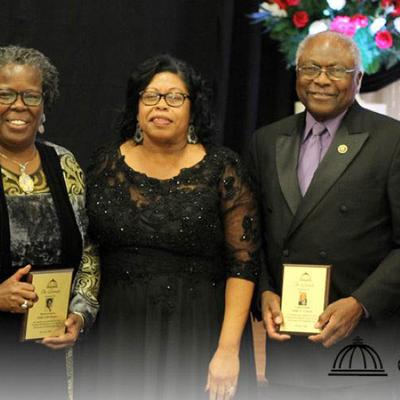 Three award recipients posing together.