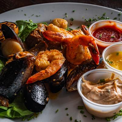Seafood boil with melted butter and cocktail sauce..