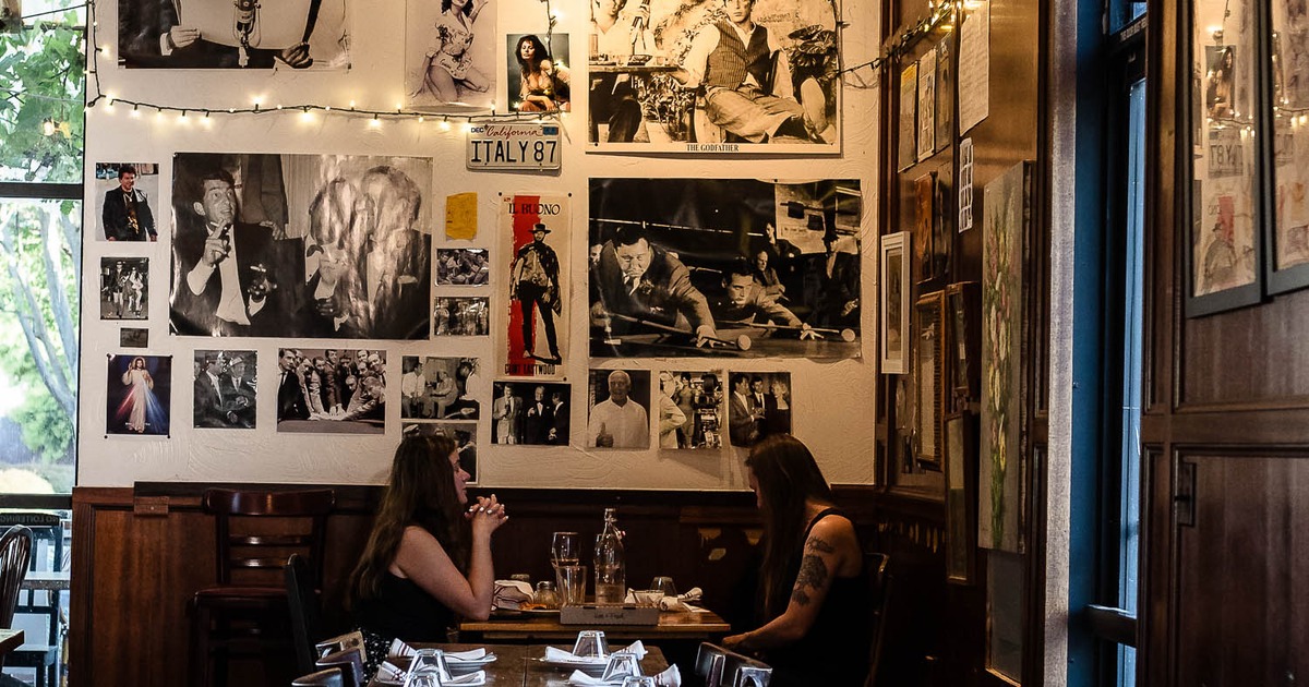 Interior, wooden table with glasses and the pictures on the wall