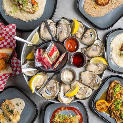 A variety of dishes, with a prominent focus on Raw oysters.