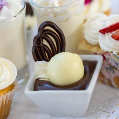 Dark chocolate mousse topped with a white chocolate truffle and a decorative chocolate swirl.