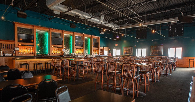 Interior seating area with bar tables and bar stools