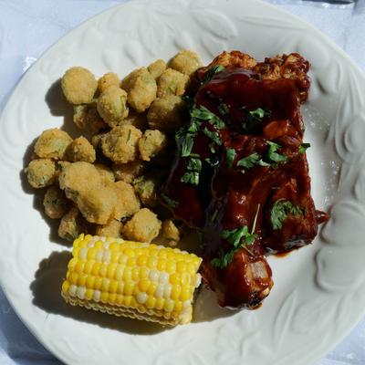 BBQ ribs with fried okra and corn on the cob.