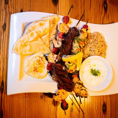 Mixed Kabob with pita, bread, hummus, rice pilaf and tzatziki