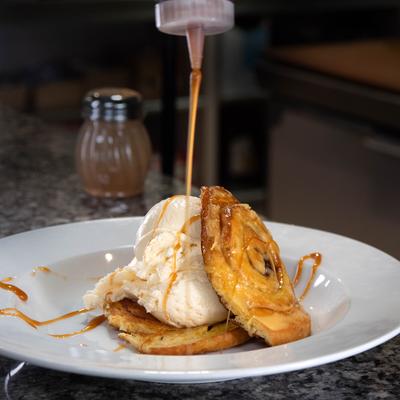 Cinnamon Carmel Sundae being drizzled with caramel sauce.