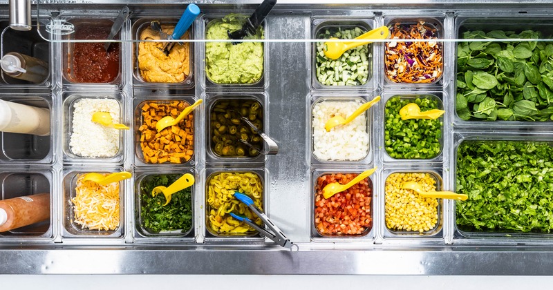 Numerous plastic containers filled with a variety of fresh ingredients