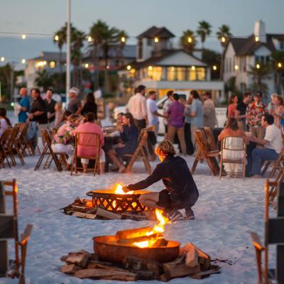 Guests outside on the sand, firepits.