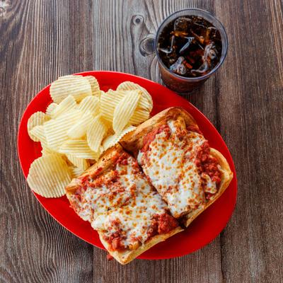 Chicken Parmigiana Sub served with chips alongside a drink.