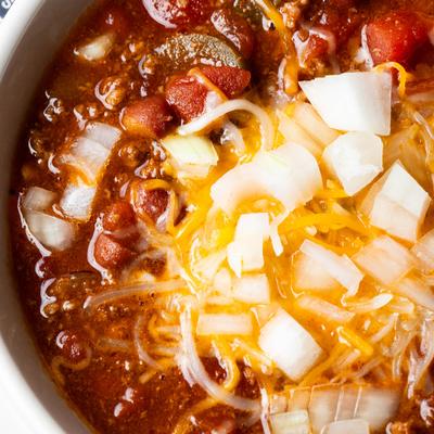 house made chili with cheese and onions served every day at the local bar.