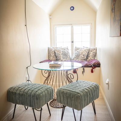 A glass table and chairs by the window.