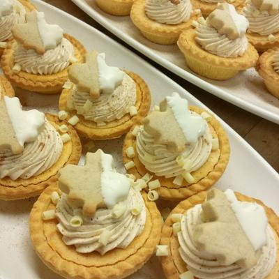 Festive tarts on white plates.