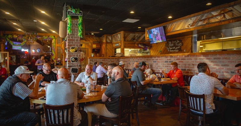 Interior, diner area, tables, chairs, people, bar, screens