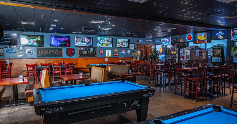 Interior, open space seating and game area, high and regular seating, pool tables, darts