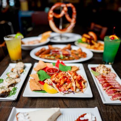 Colorful table spread of assorted appetizers and cocktails.