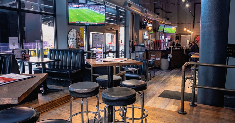 Interior space, tables, stools, booths, and a bar area