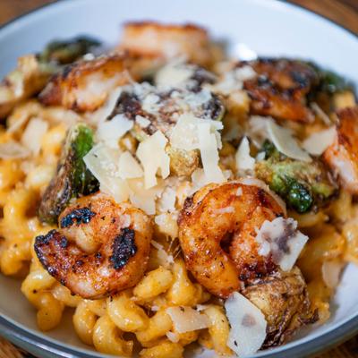 Shrimp mac and cheese topped with Brussels sprouts and Parmesan cheese.