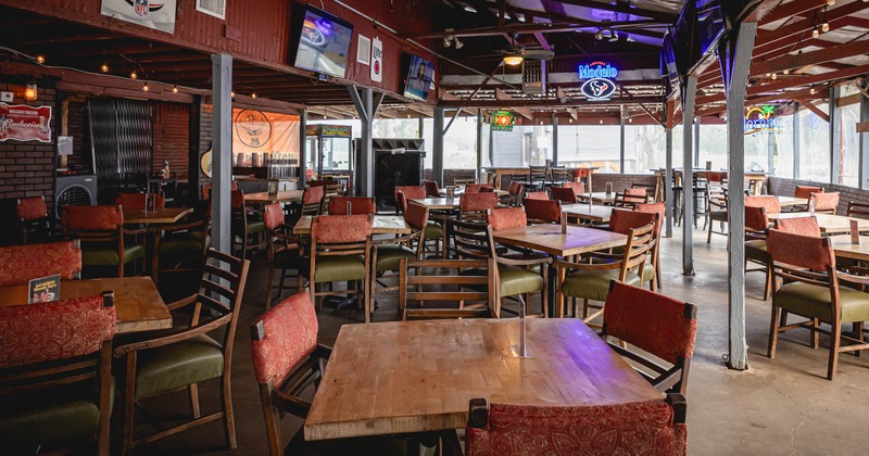 Interior, dining area, tables and chairs, TVs on the wall