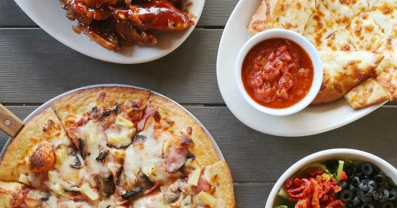 A served pizza and other meals