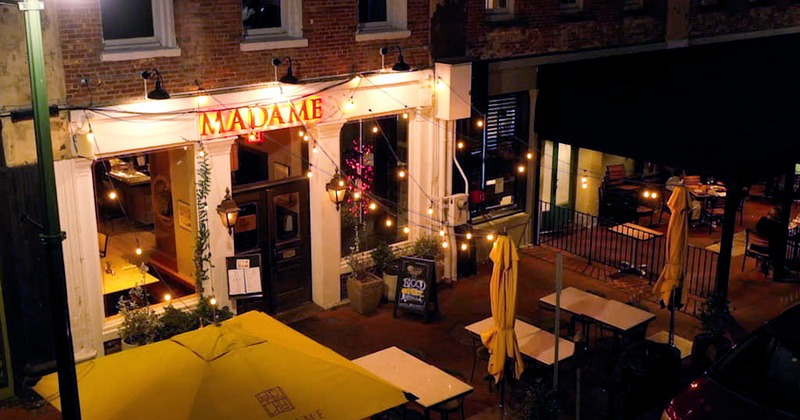 Interior, tables, benches, chairs, brick walls, windows, lighting, plants