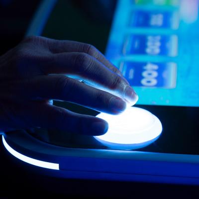 Hand pressing a slot machine button.