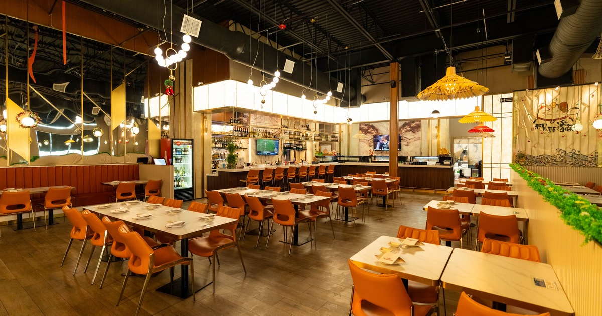 Spacious restaurant interior with dining tables and bar seating