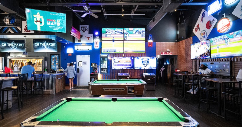 Interior, pool tables with bar in the back