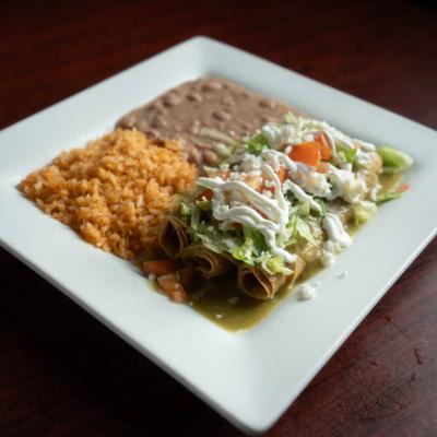 Pork rib sauteed in tomatillo sauce and served with rice and beans.