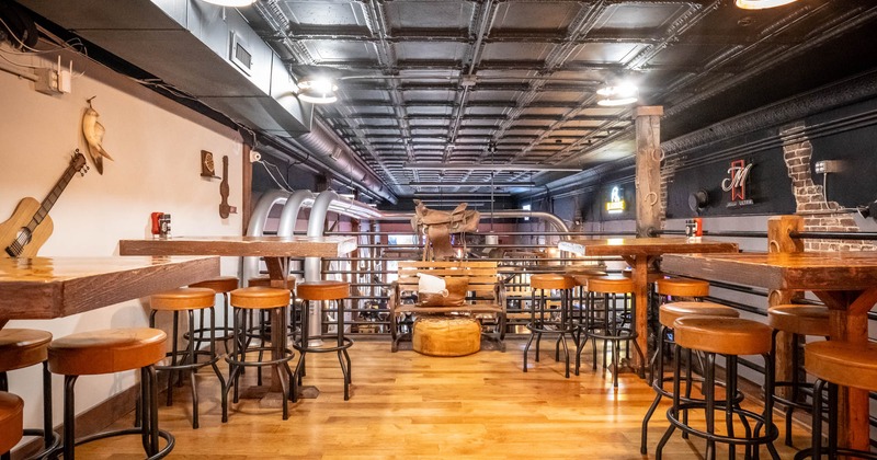 Interior, upstairs seating area, high wooden top tables with bar stools, small bench