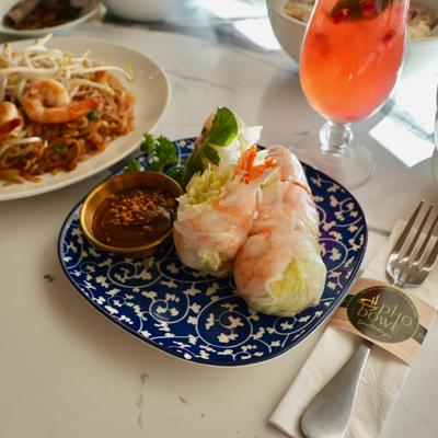 Shrimp Roll served on the table with one more dish and a drink.