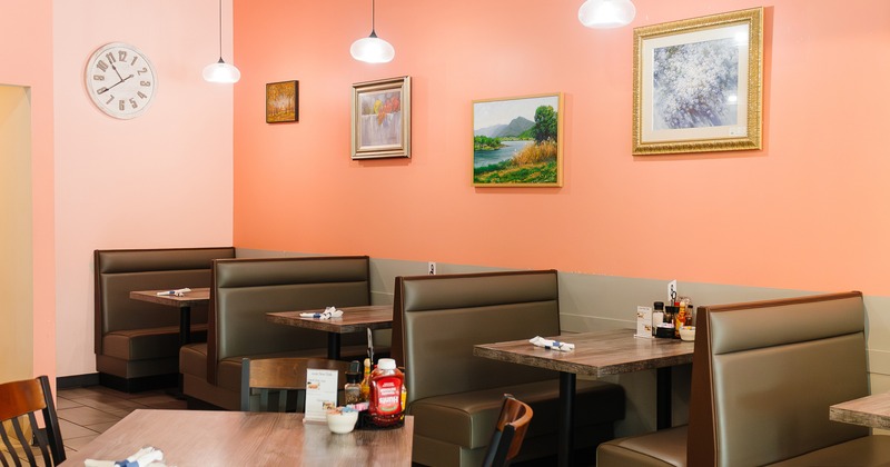 Cozy interior dining area with upholstered dining booths along the wall